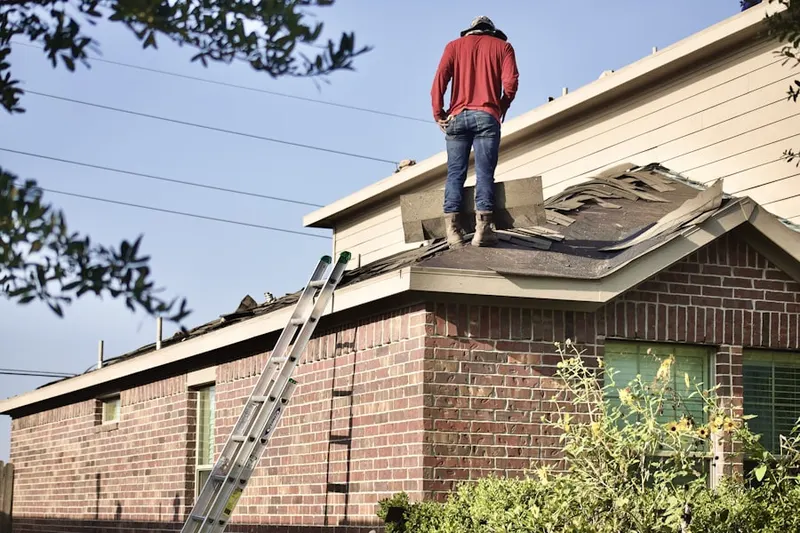 Professional roofer working on a residential roof in Dysart Ranch